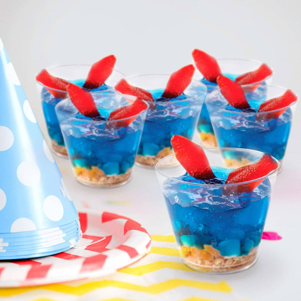 Red gummy fish candy toppers on blue gelatin cups