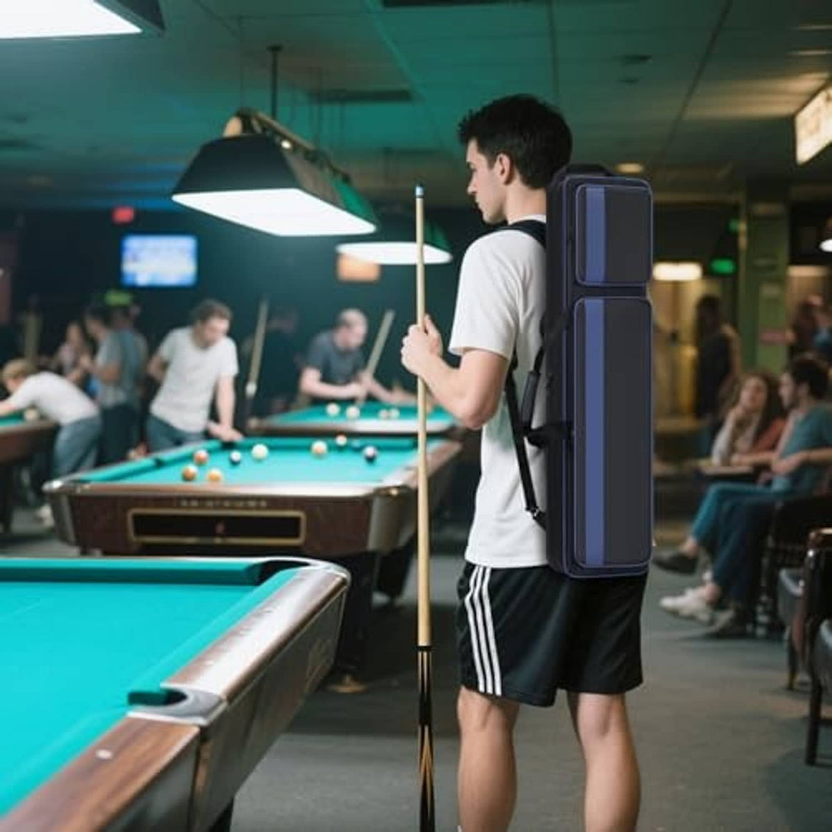 Navy-blue pool cue case held upright with shoulder strap, soft padded body