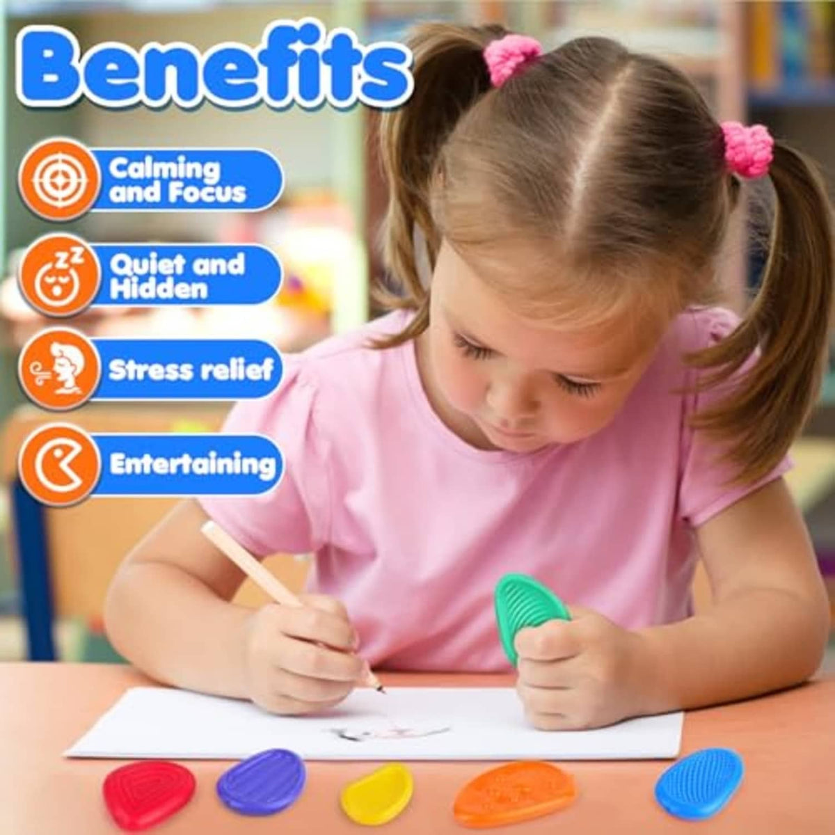 Child holding a green textured worry stone while drawing, sensory fidget toy
