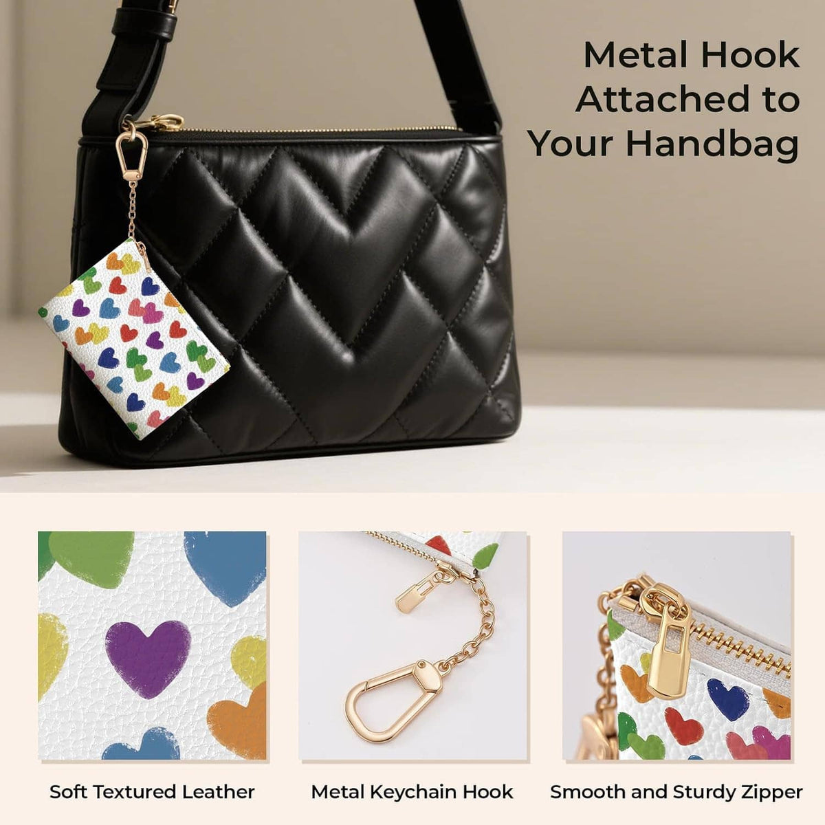 Heart-pattern zip coin purse with gold keychain hook attached to a black quilted bag.
