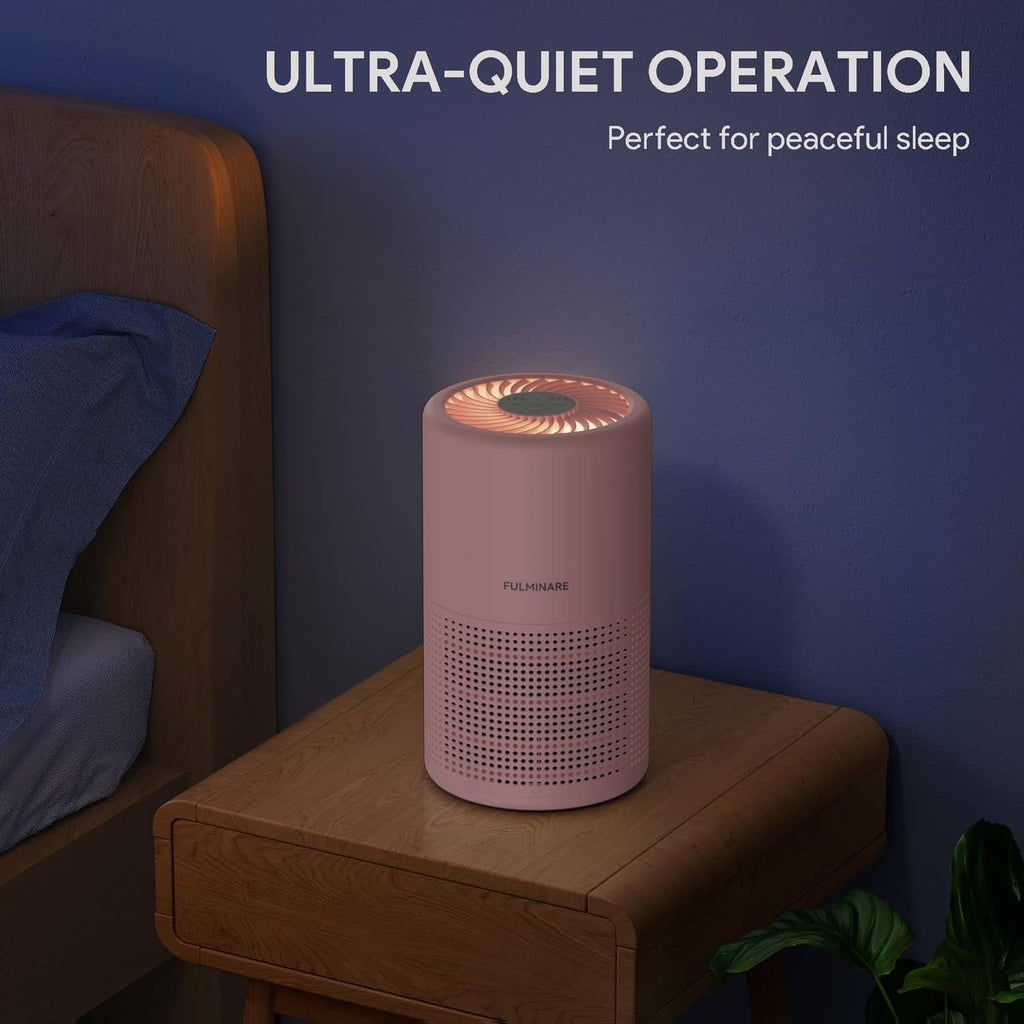 Pink air purifier on a bedside table with quiet operation glow