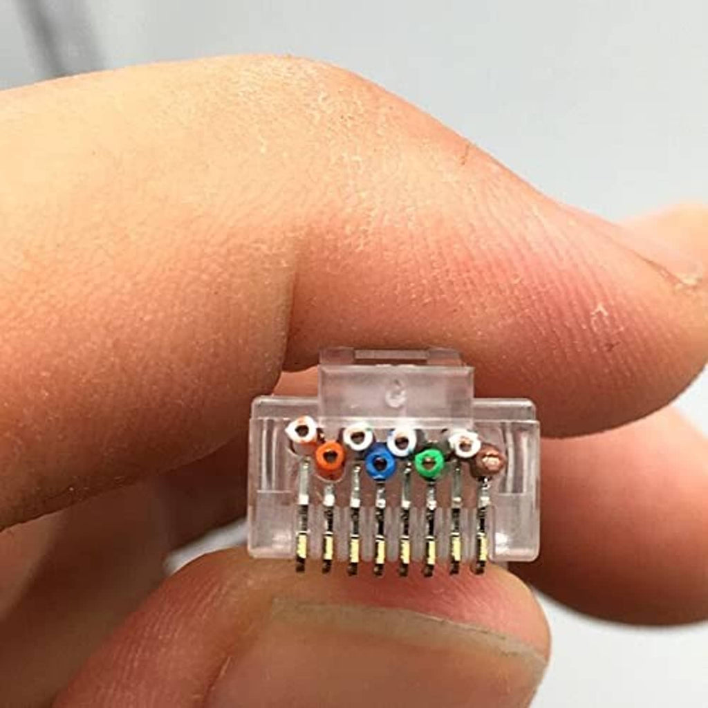 Close-up RJ45 connector showing gold pins and color-coded wire terminals