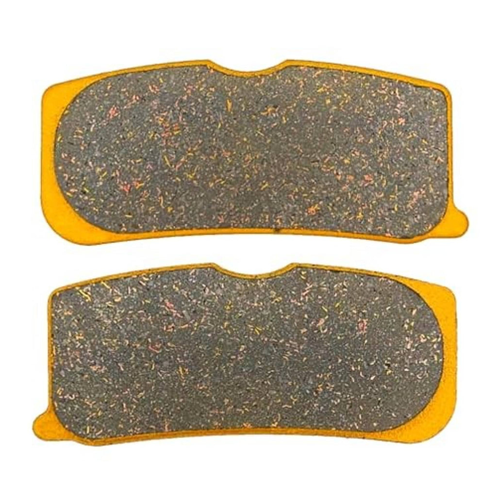 Ceramic brake pads, two gray friction pad shapes with yellow edges and scalloped backing