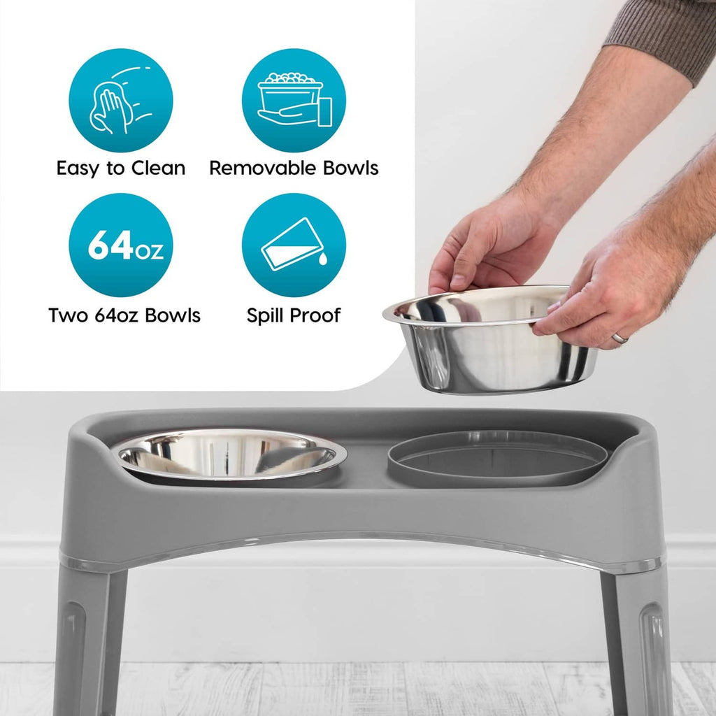 Grey elevated dog bowls with two stainless bowls; one bowl held by hand