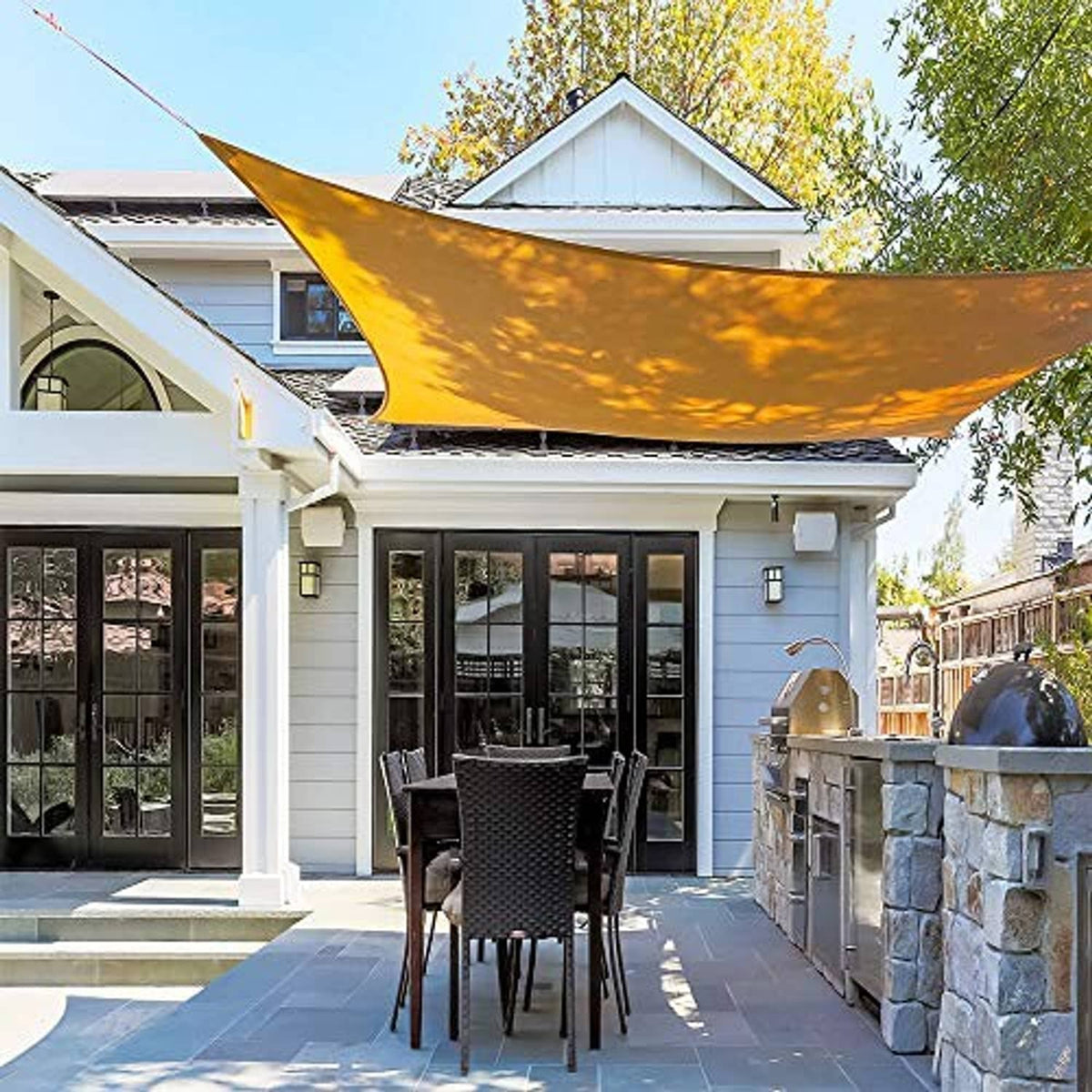 Tan shade sail stretched over patio area with secure corner fittings