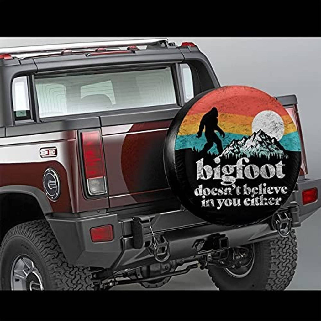 Black RV spare tire cover with Bigfoot graphic mounted on a vehicle rear