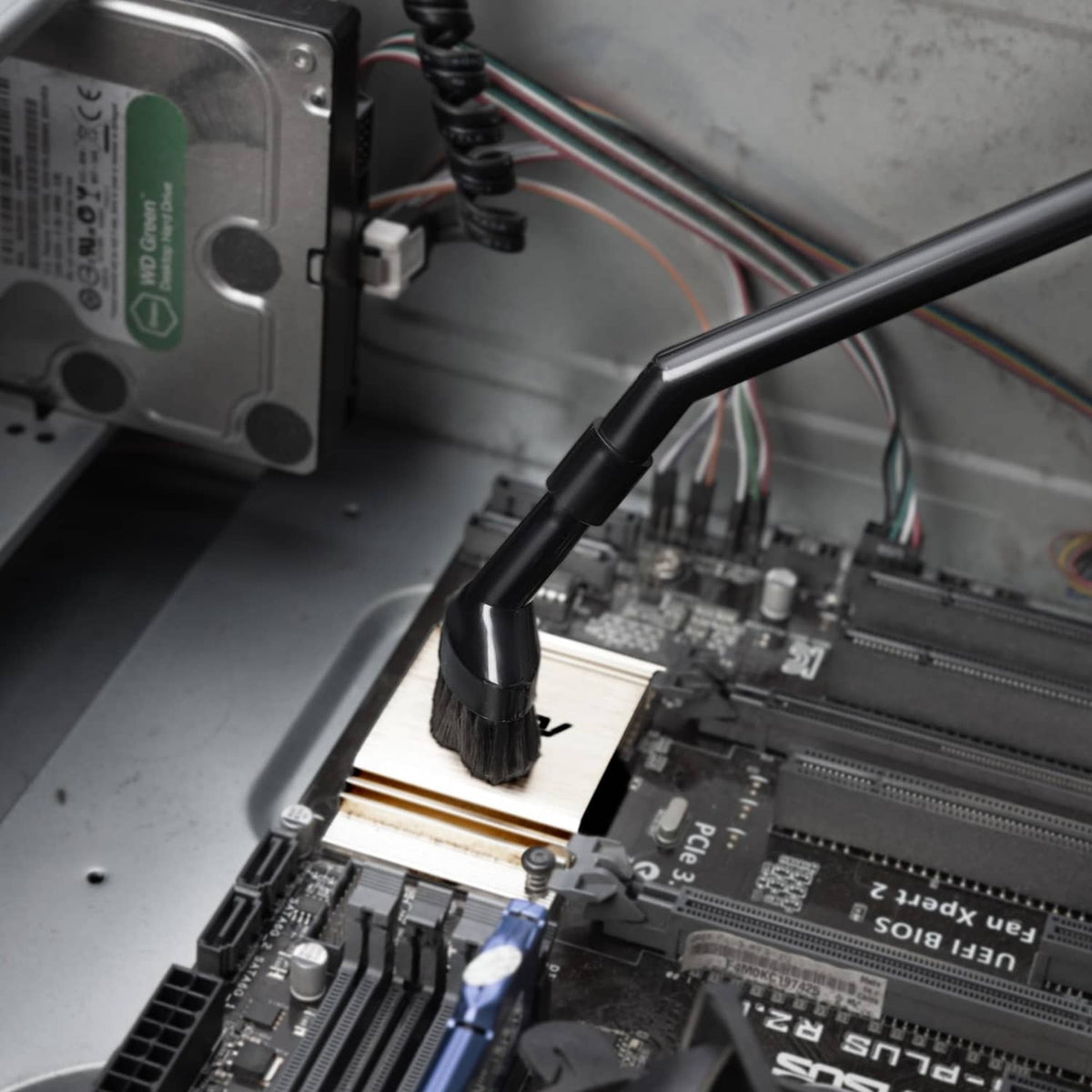 Black micro brush nozzle cleaning circuit board and components in a computer