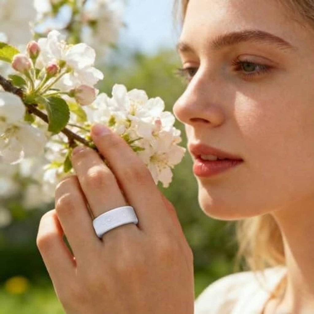 Woman wearing a light gray ring cover with embossed floral pattern on a wide band