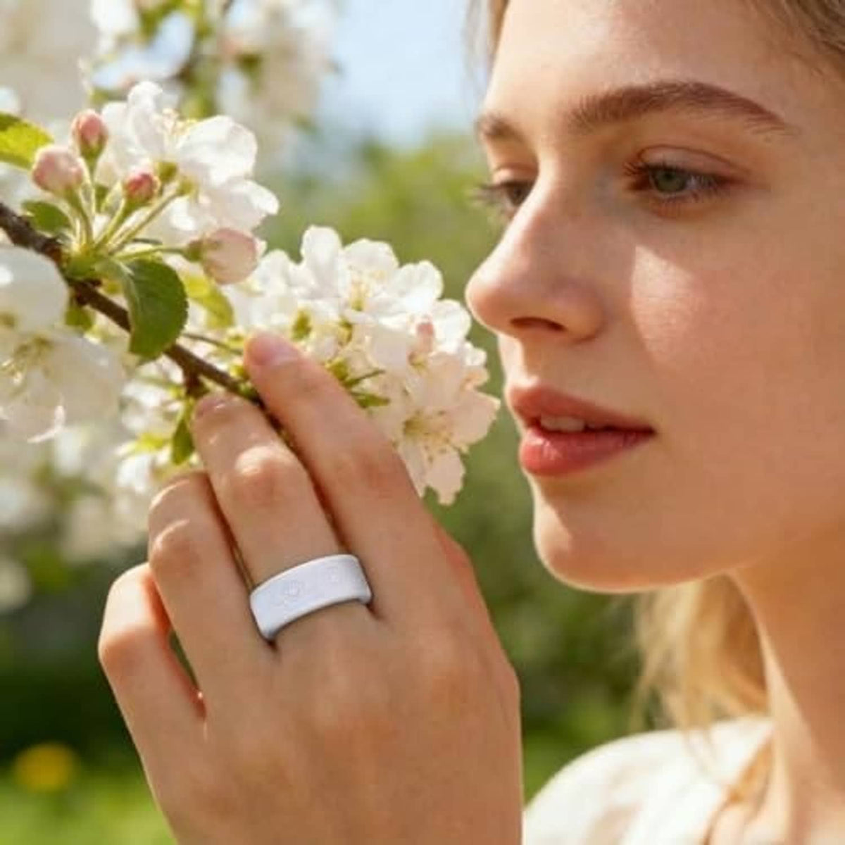 Woman wearing a light gray ring cover with embossed floral pattern on a wide band