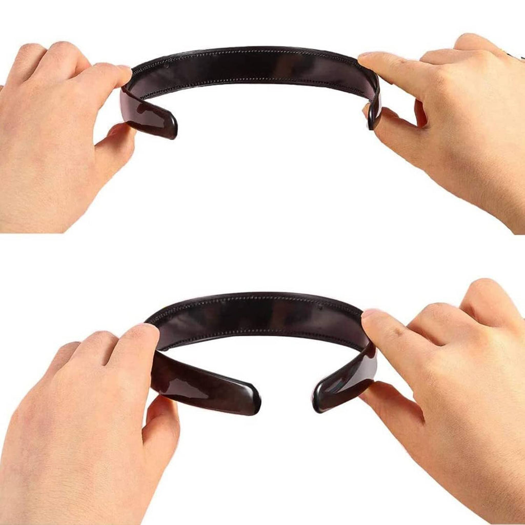 Black elastic hair band with teeth, shown stretched open by hands