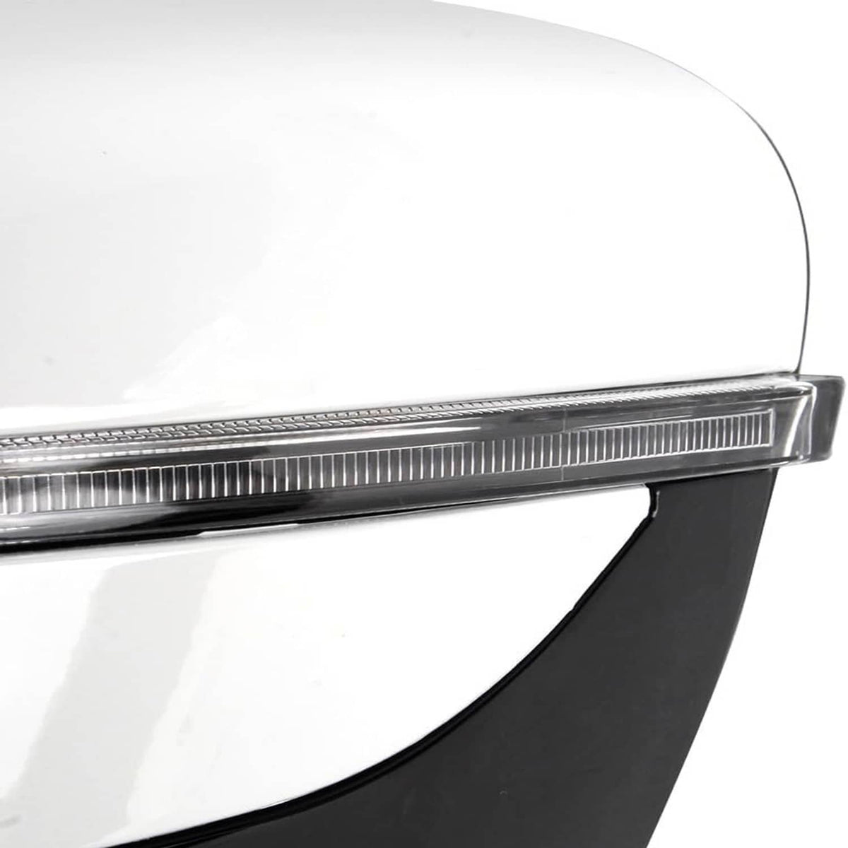 White vehicle fender edge with chrome trim and black lower panel