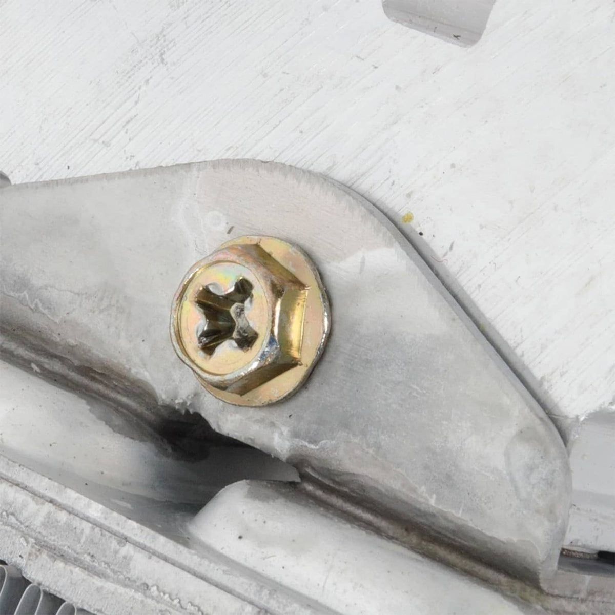 Automatic transmission oil cooler close-up of mounting bolt on metal housing