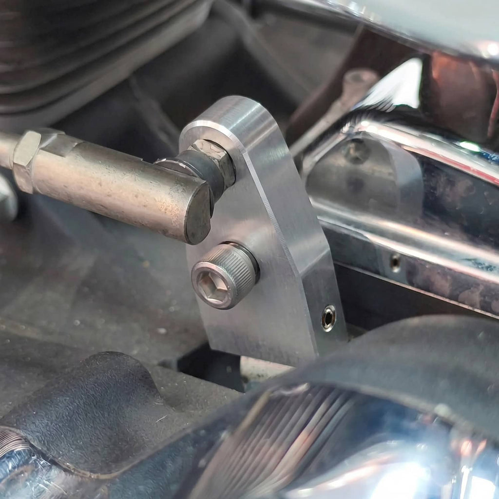 Chrome shift assist bracket mounted near engine with machined plate and bolts
