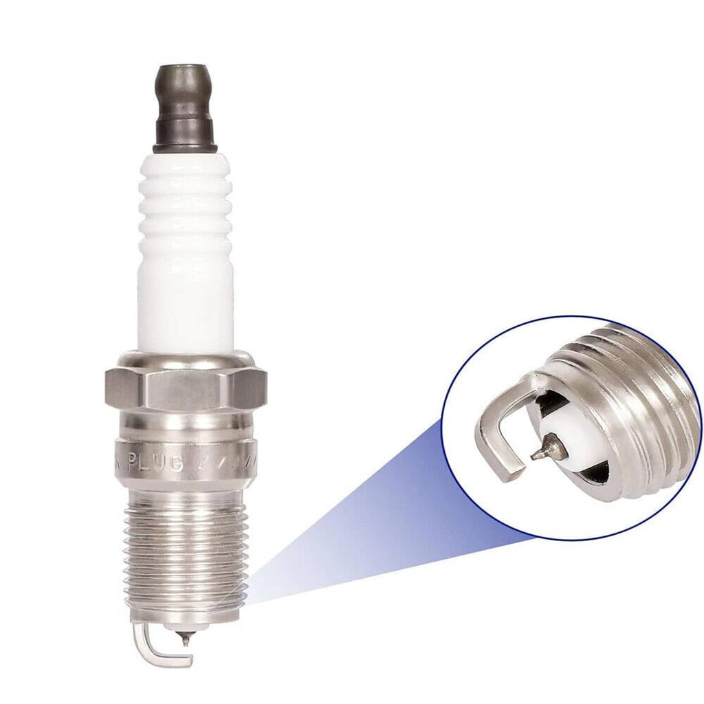 Spark plug with white insulator and metal tip; inset shows terminal detail