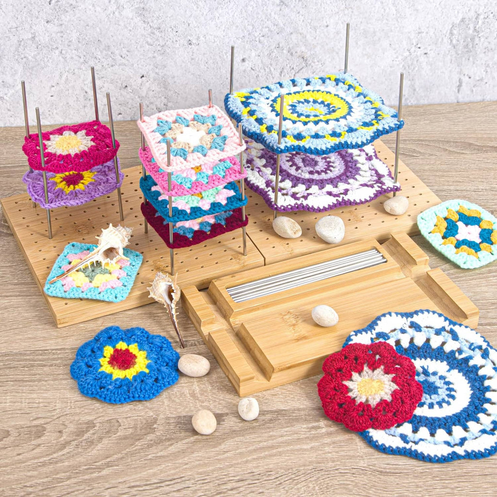 Crochet blocking board with peg pins holding colorful crochet coasters