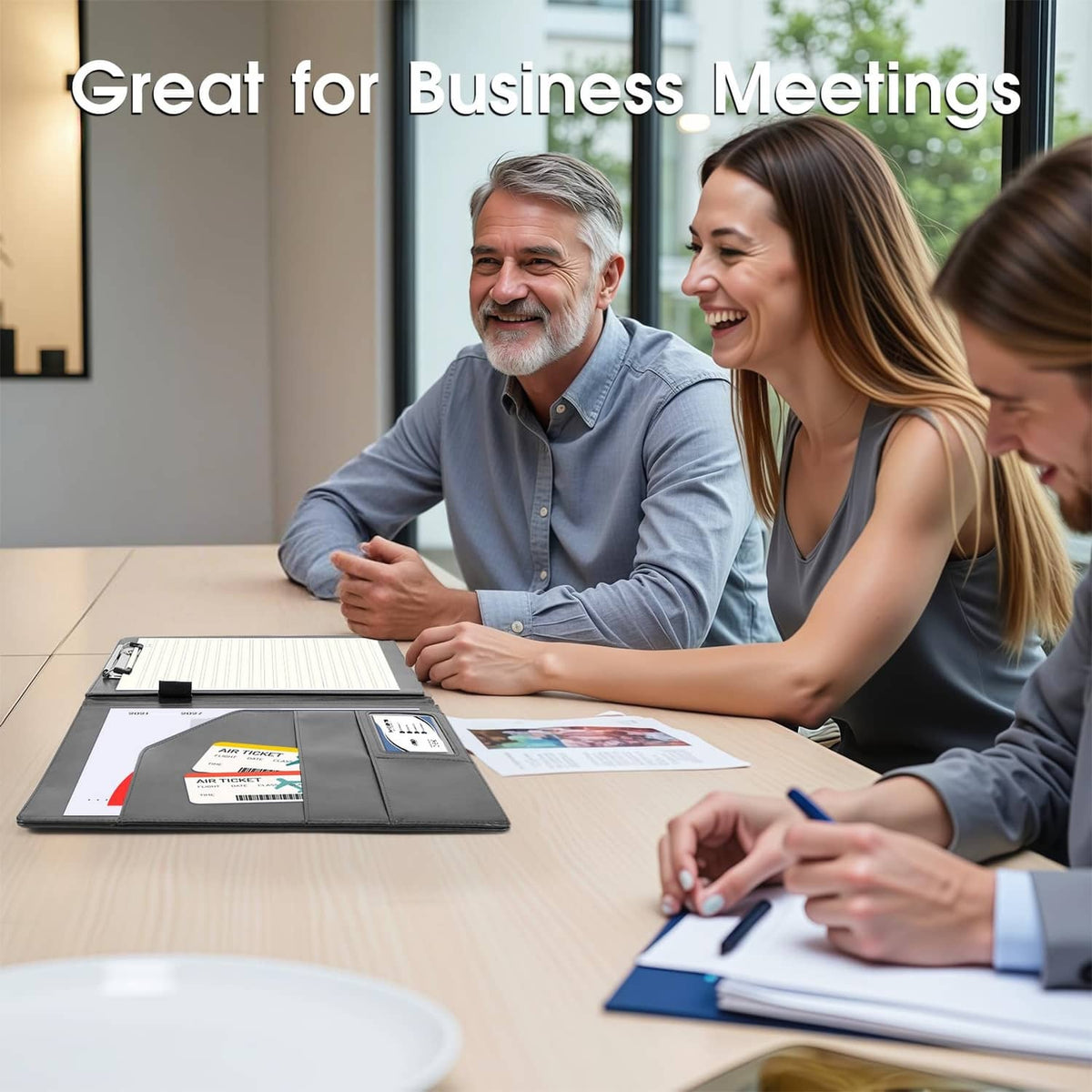 Black faux leather binder with clipboard open on meeting table