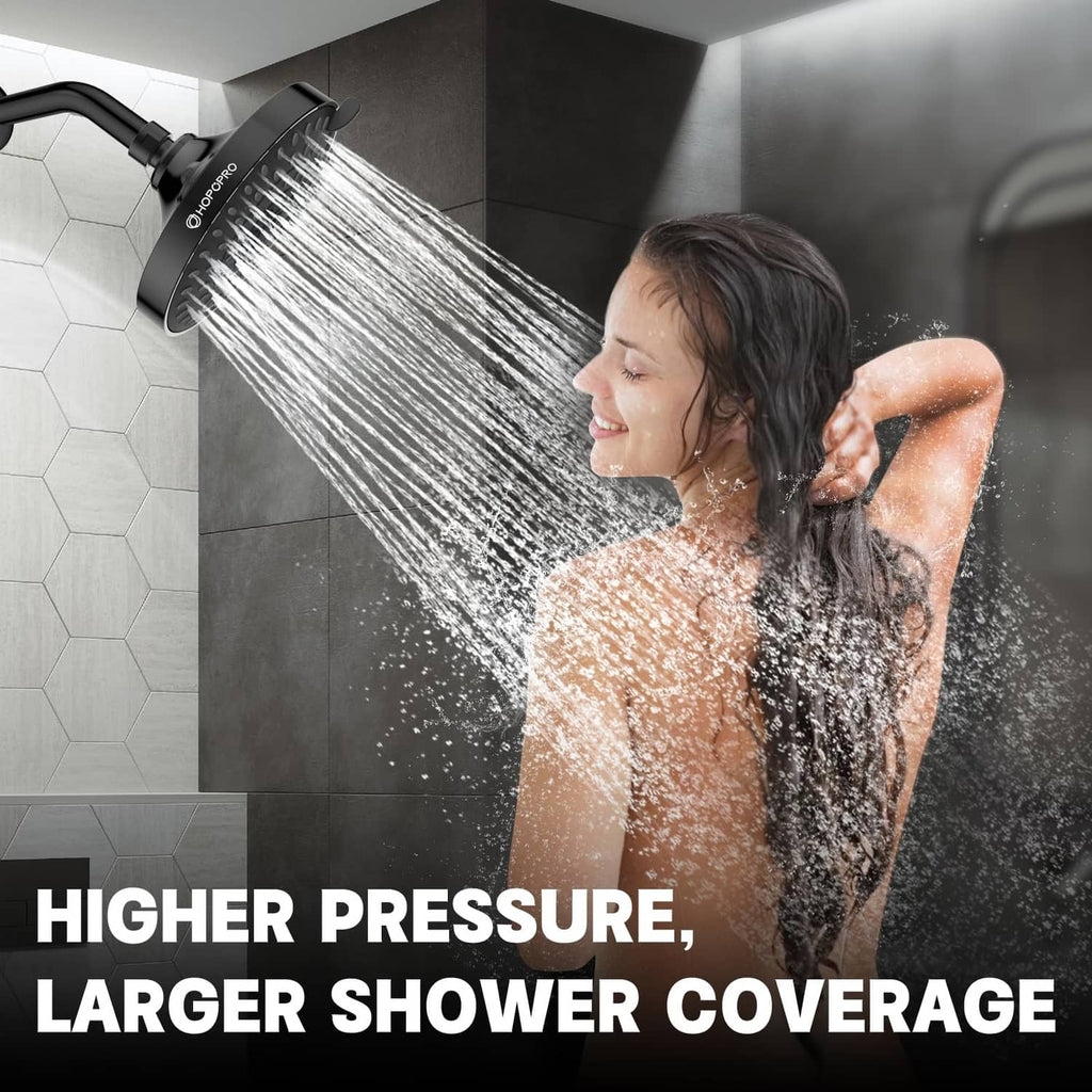 Matte black overhead shower head spraying a wide stream of water