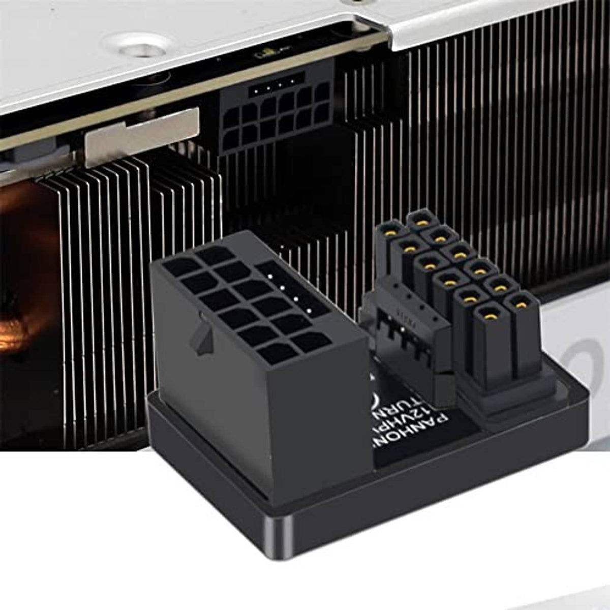 Black 12VHPWR 16+4 pin adapter with dual connector ports beside a GPU