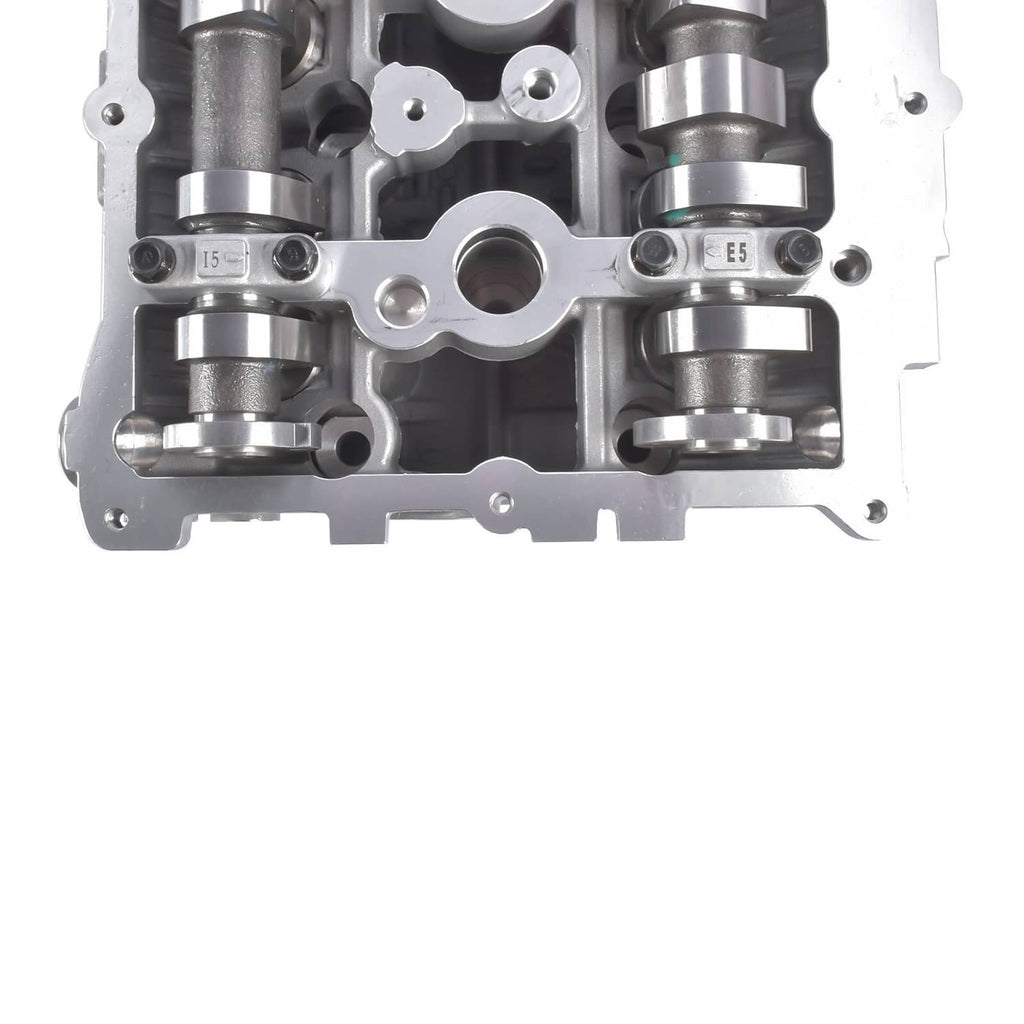 Cylinder head close-up with valve spring areas and camshaft journals, bare metal.