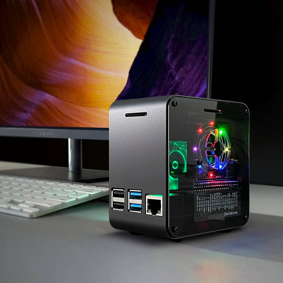 Aluminum mini tower Raspberry Pi case showing side ports and RGB-lit interior fan.