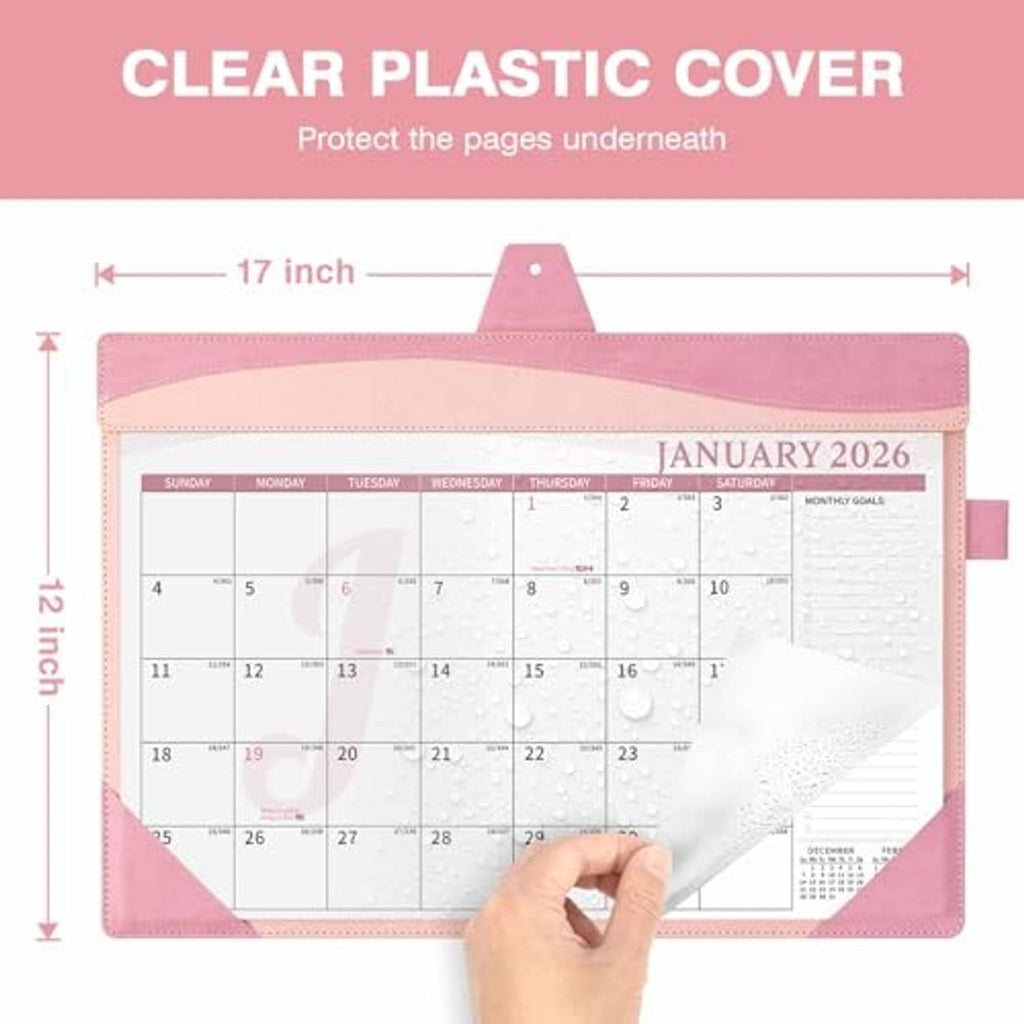 Pink desk calendar with clear plastic cover and hanging hole, open to January 2026