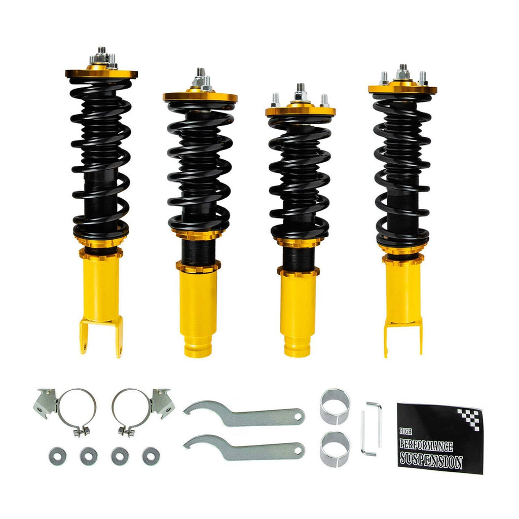 Coilover suspension kit with black springs and yellow shock bodies, plus mounting hardware