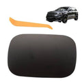 Black fuel tank filler door cover with gas cap opening, smooth rounded shape
