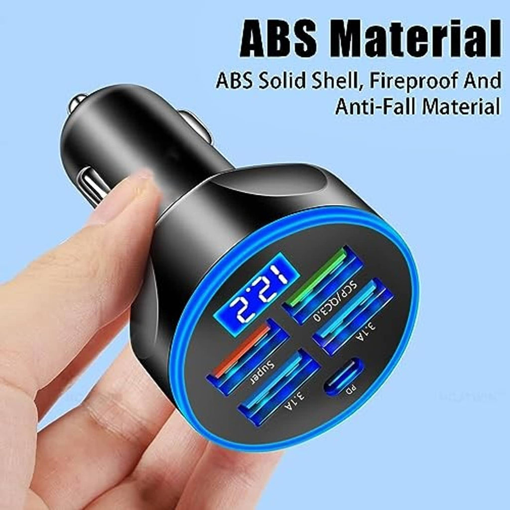 Black car charger with LED voltmeter, four USB ports and Type-C, held by hand