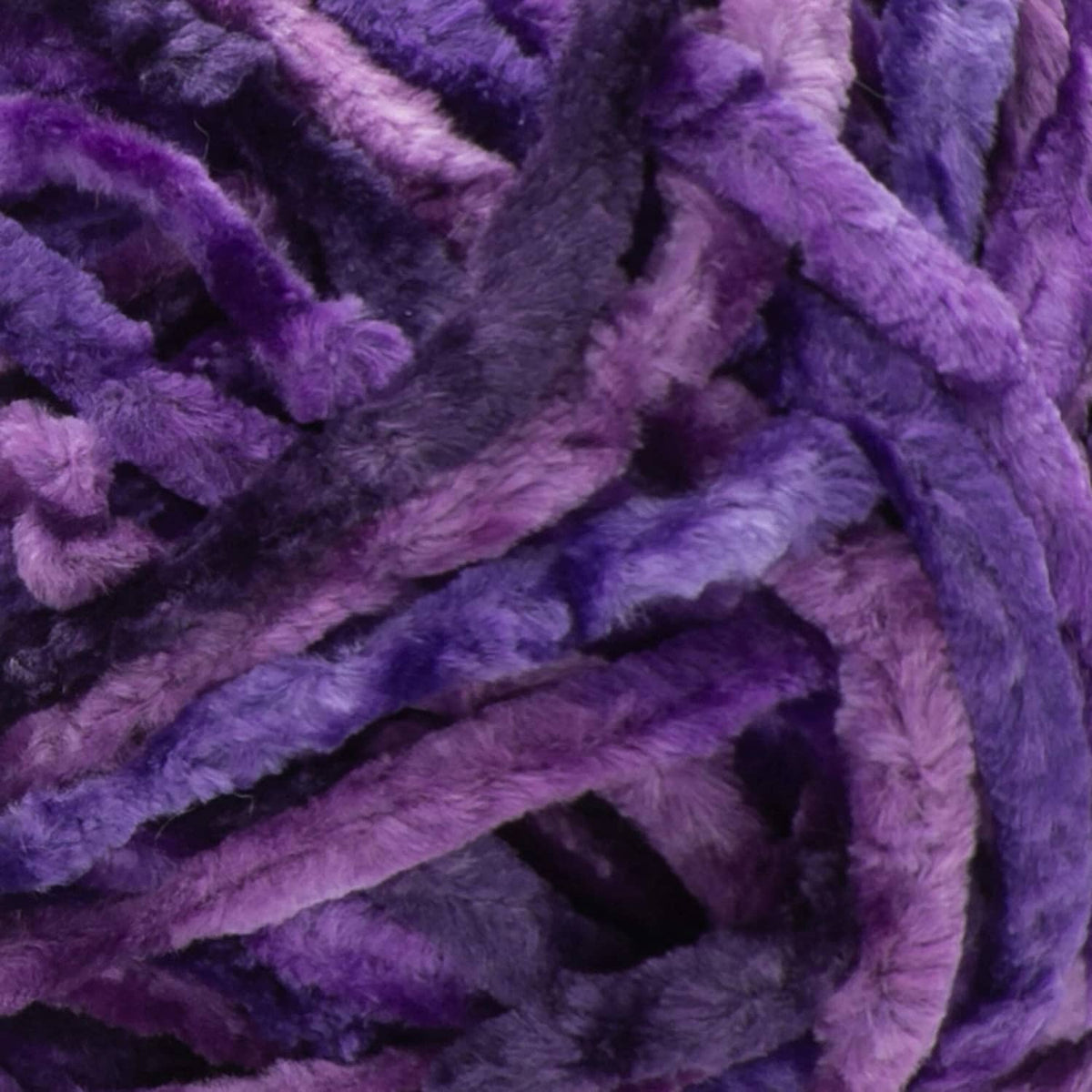 Potent purple crushed velvet yarn close-up with thick, looped textured fiber