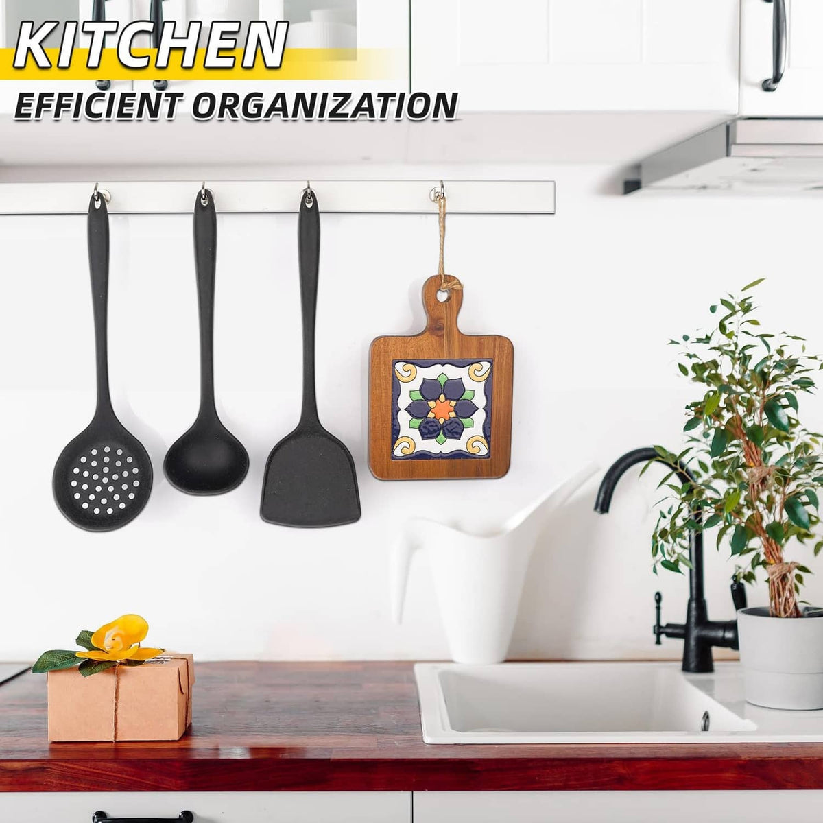 Silver magnetic hooks holding kitchen utensils on a metal bar