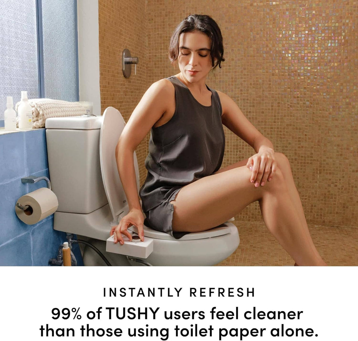 White non-electric bidet attachment on toilet seat with user seated in bathroom