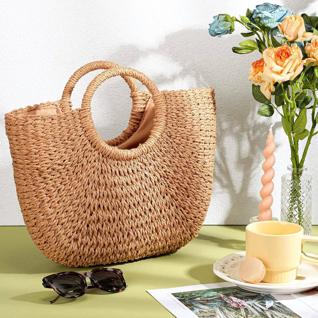 Light brown woven straw tote bag with round handle, side view