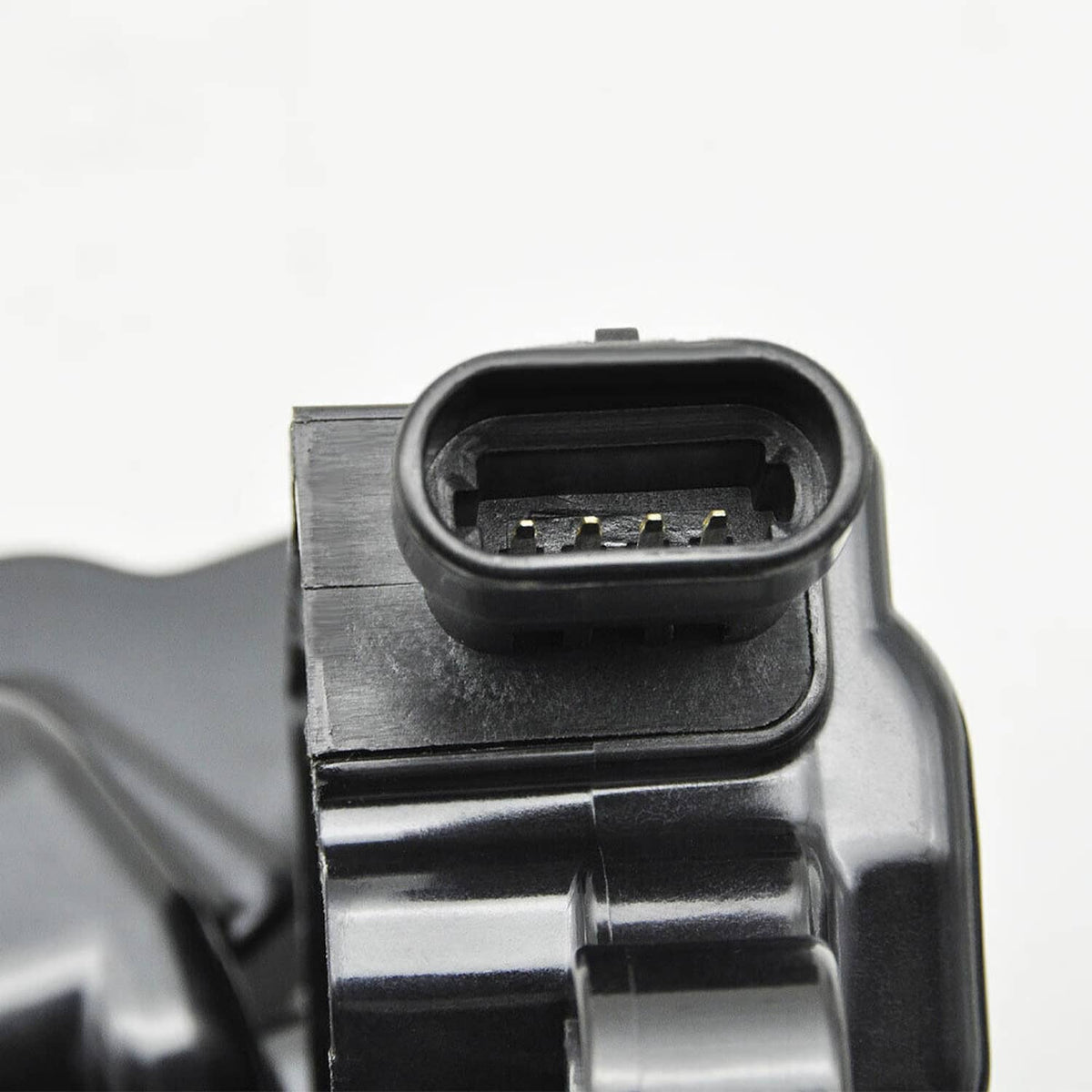 Close-up of ignition coil connector and terminals with black housing and metal body