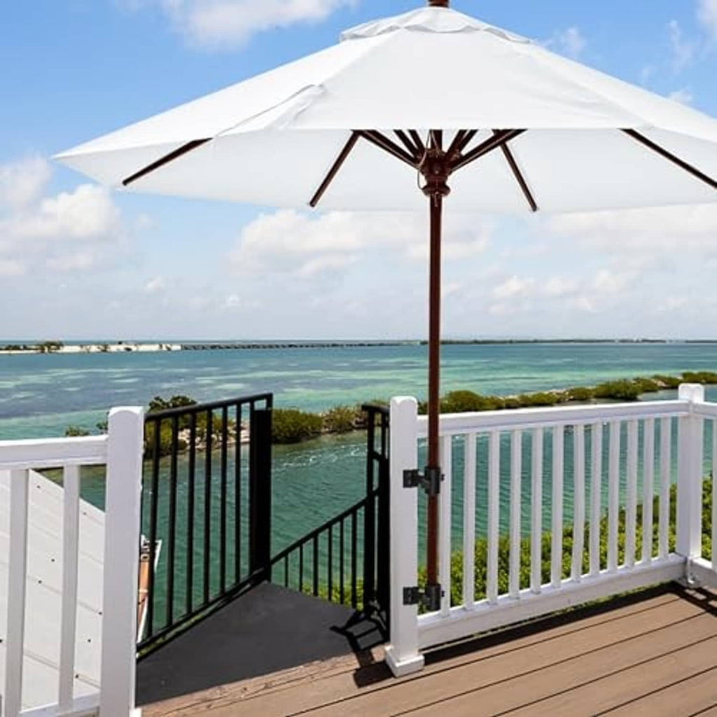 Black umbrella deck mount holder clamped to railing with umbrella pole support