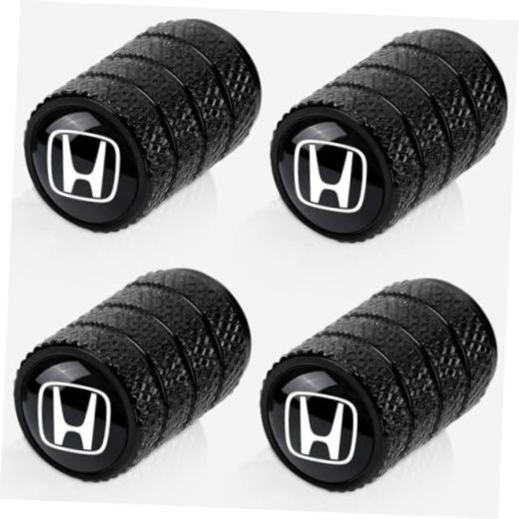 Set of 4 black tire valve stem caps with white Honda logo, textured grip