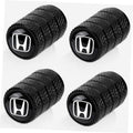 Set of 4 black tire valve stem caps with white Honda logo, textured grip
