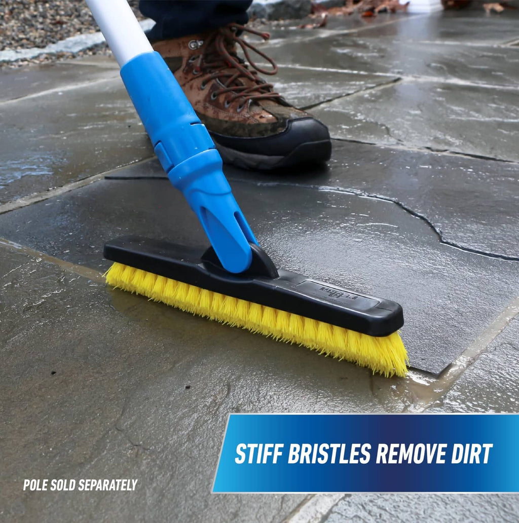 Swivel grout brush scrubbing tile floor with yellow bristles and blue swivel head