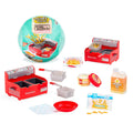 Mini kitchen appliance playset with red stove, cookware trays, and food props