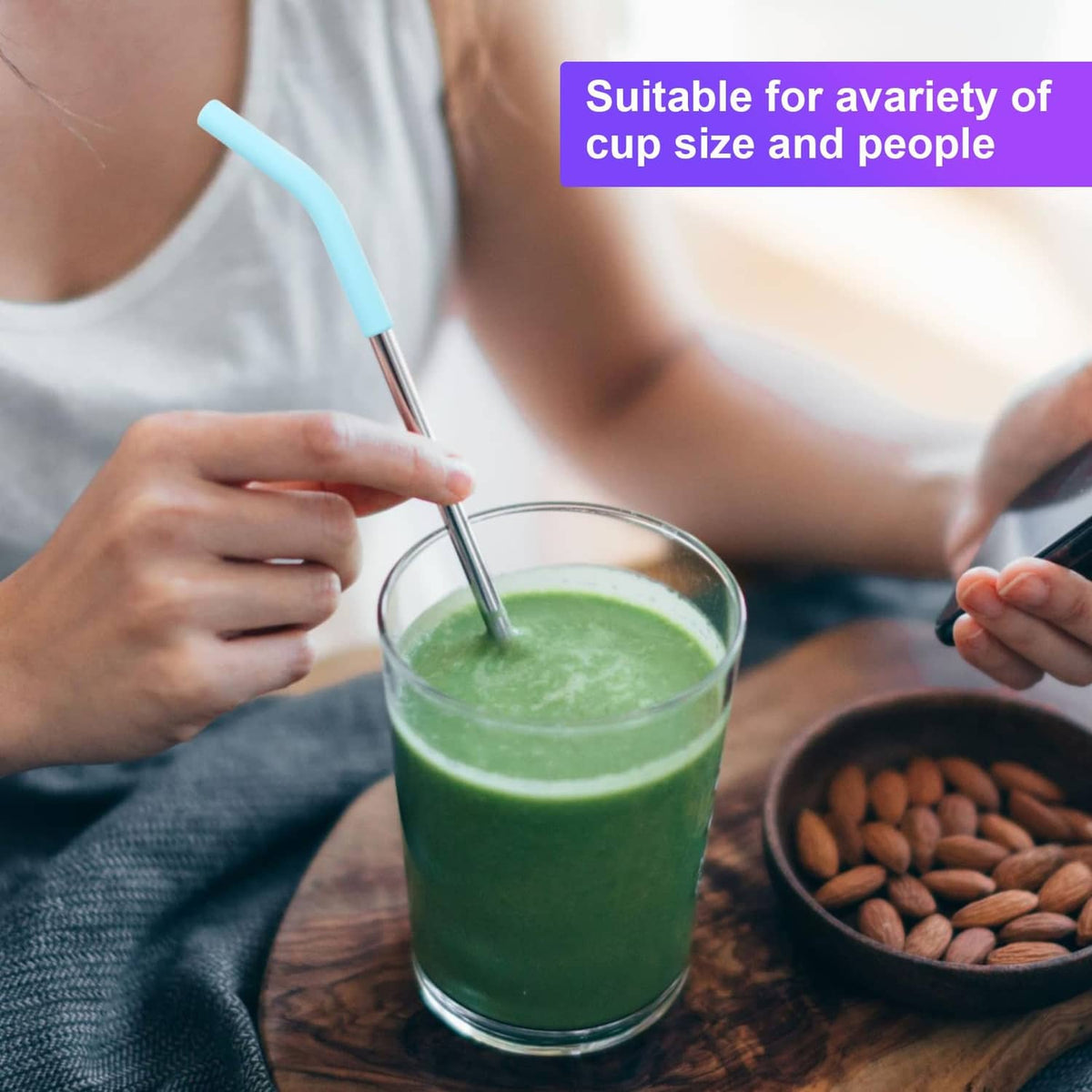 Light blue silicone straw elbow tip used in a green smoothie cup