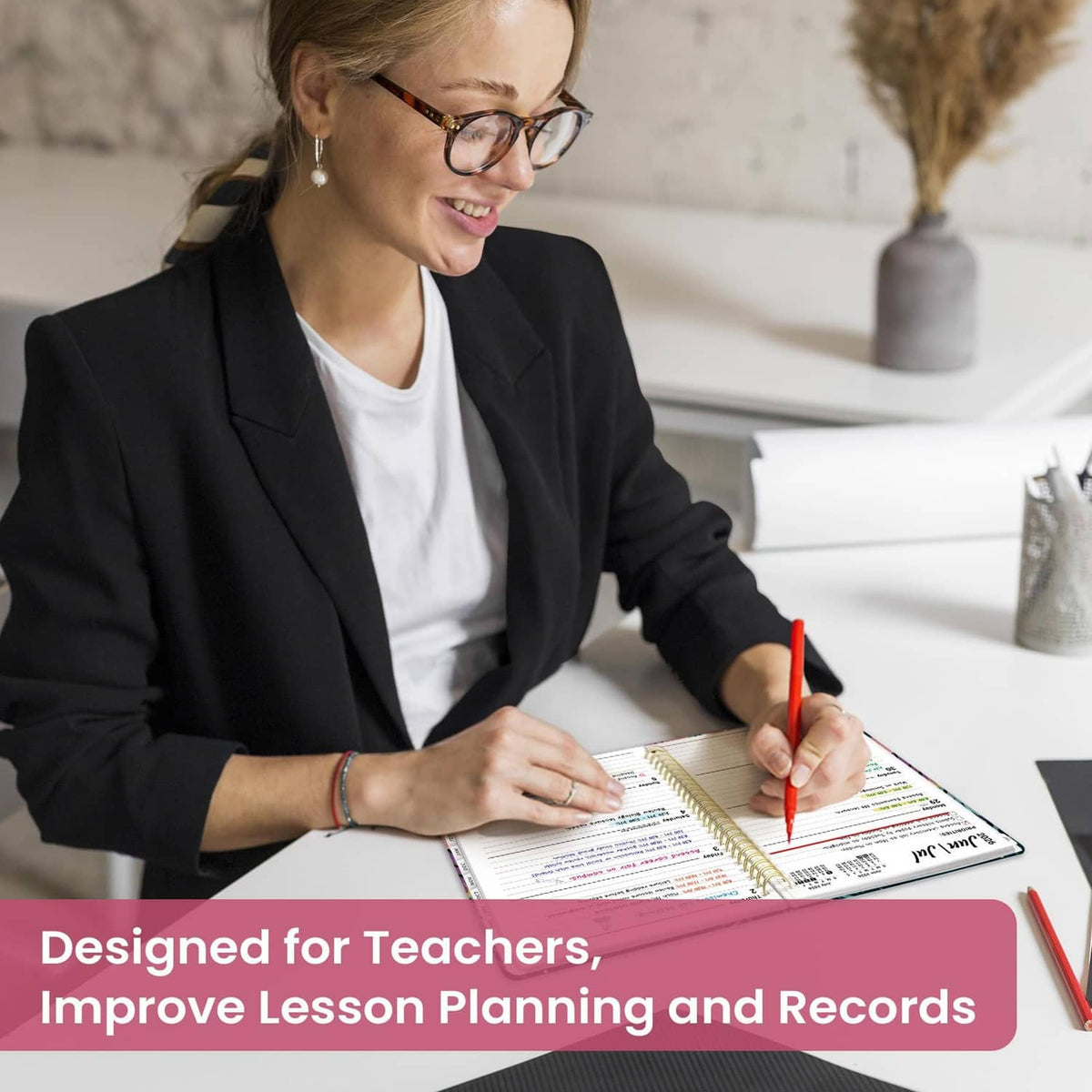Teacher writing in an academic planner during lesson planning
