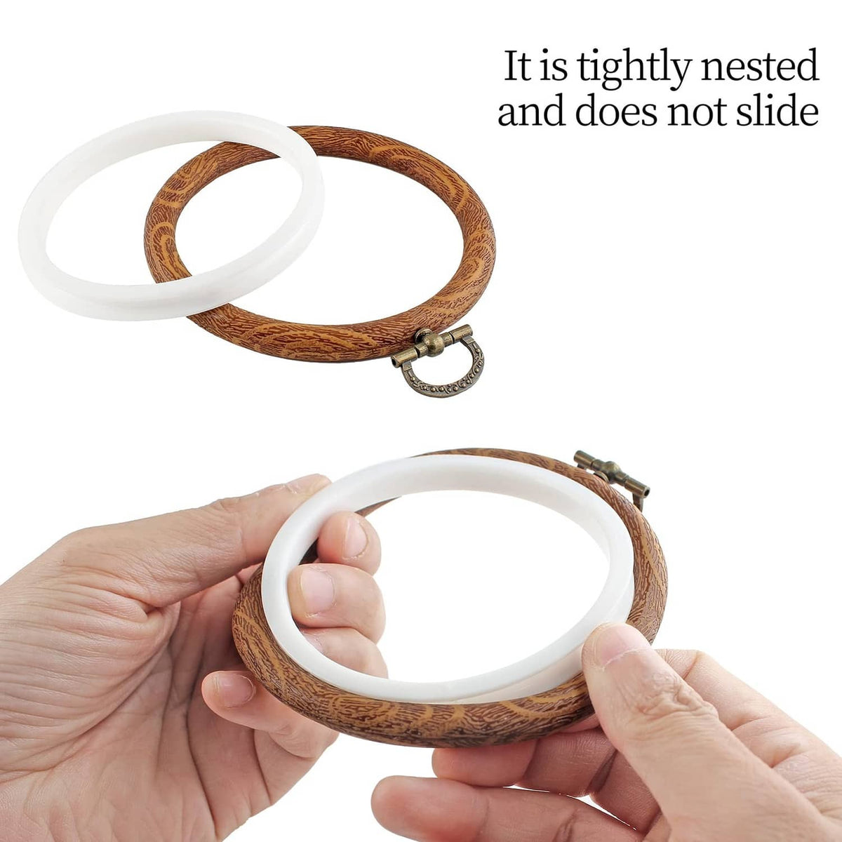 Embroidery hoop with brown faux wood outer ring, white inner ring, and metal clasp
