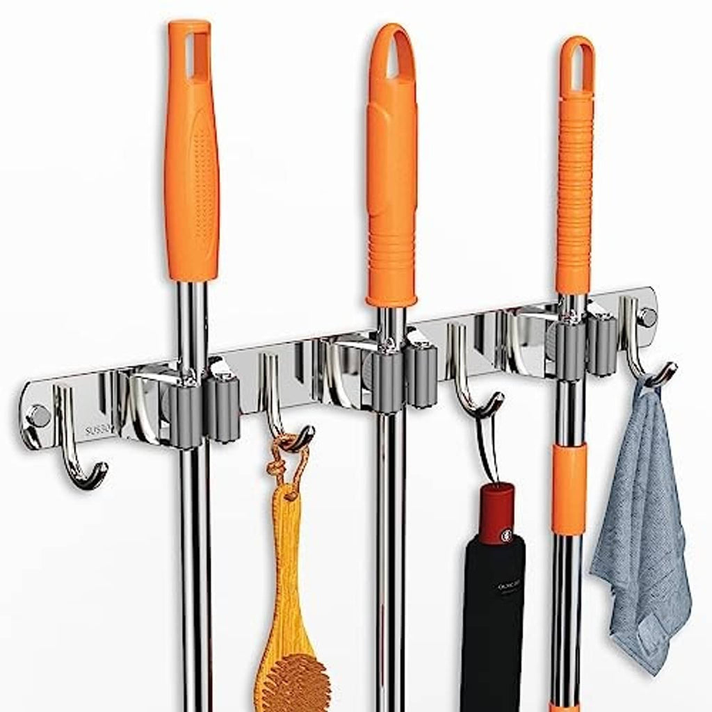 Chrome wall-mount broom holder with three vertical slots, four hooks, and orange broom handles