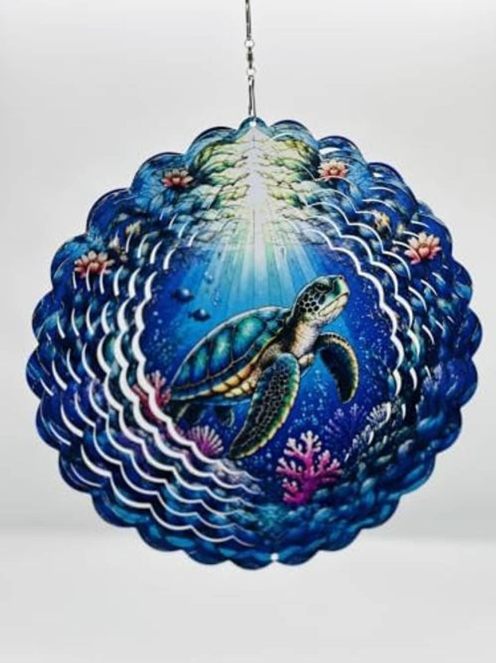 Blue sea turtle wind spinner close-up with layered scalloped wave edges