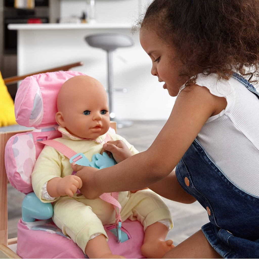 Pink doll car booster seat holding a baby doll with adjustable pink harness and blue accents
