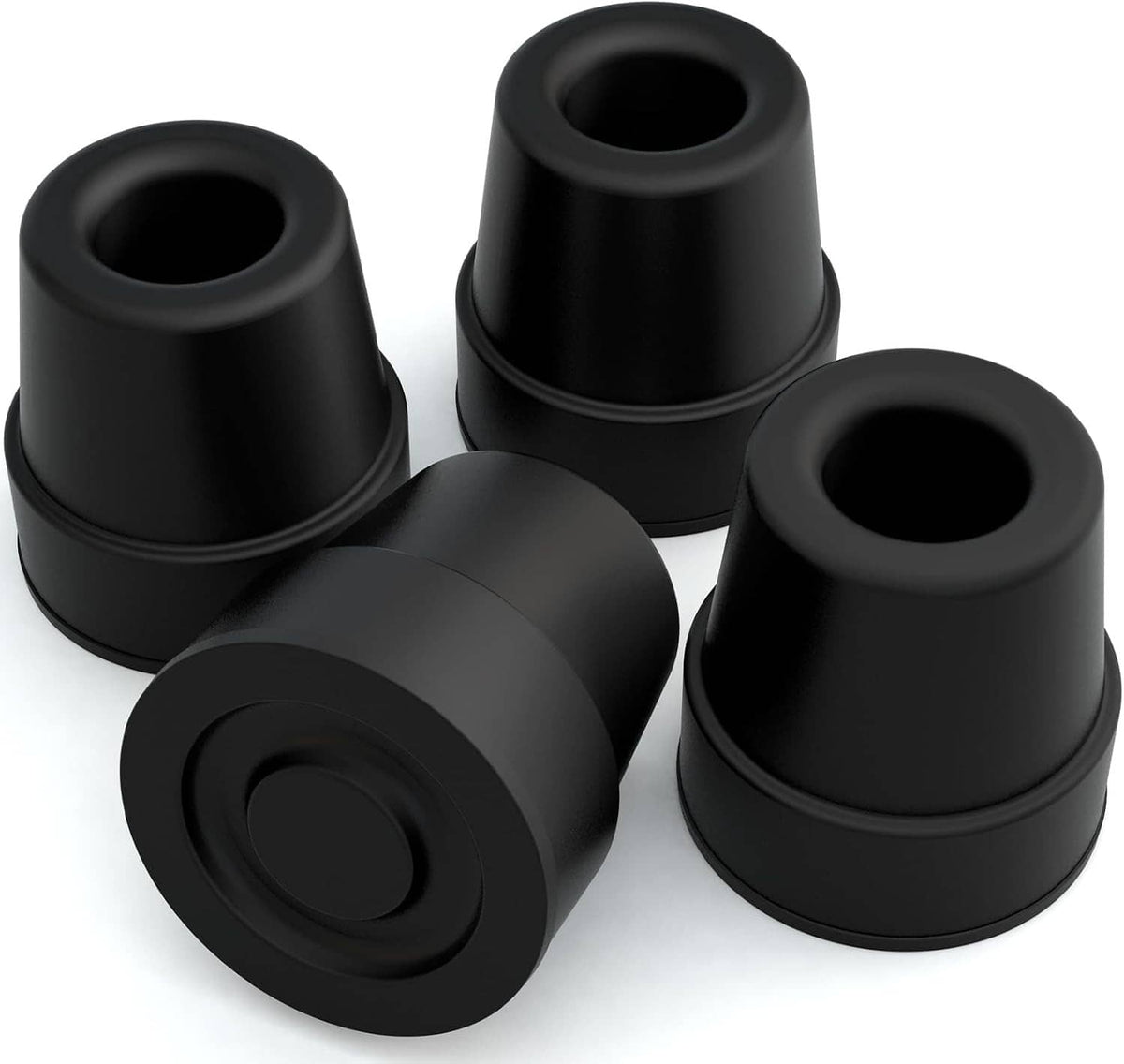 Four black quad cane replacement rubber tips, close-up set
