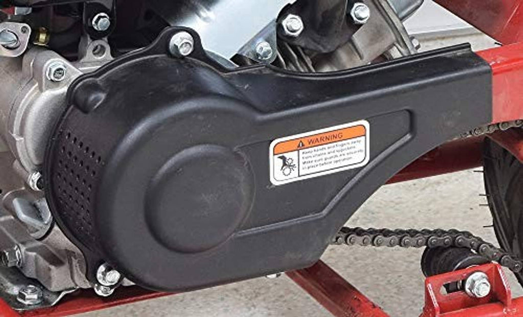 Black plastic clutch cover on engine housing with warning label and bolts
