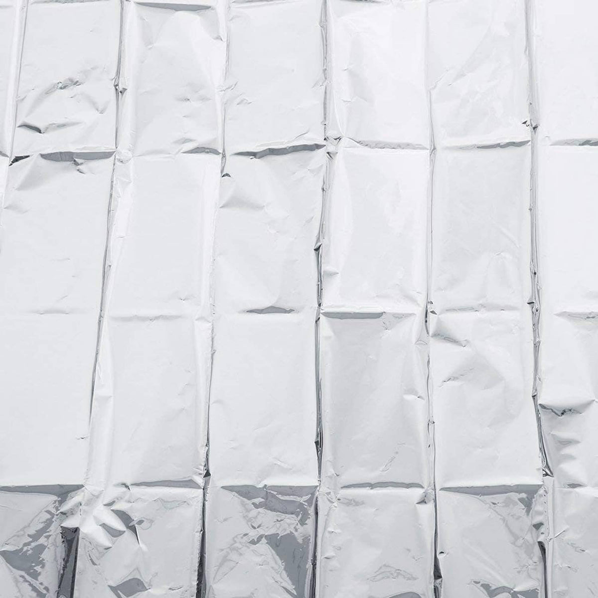 Silver reflective mylar film close-up, textured crinkle foil panels