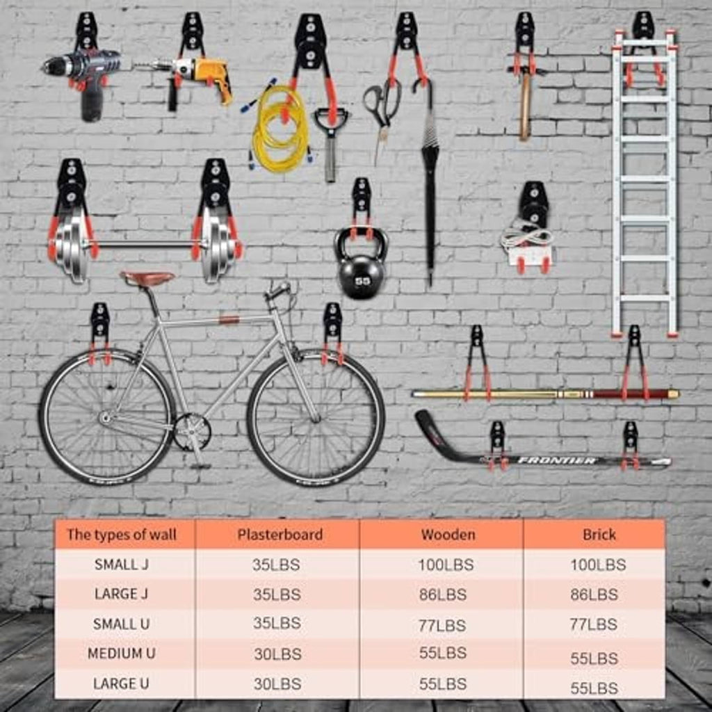 Multiple garage wall hooks on a brick surface, black mounts with orange J-style ends