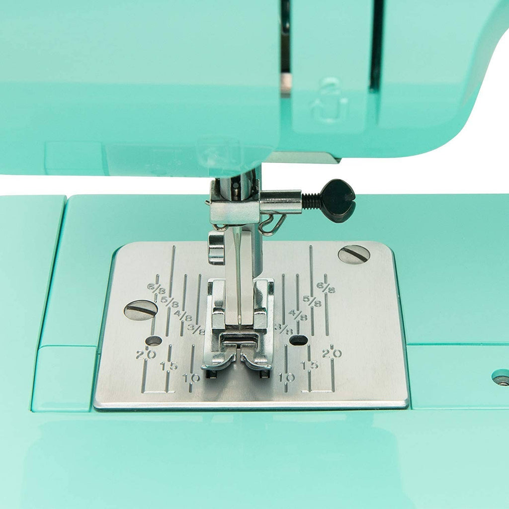 Turquoise presser foot and metal feed plate with stitch guide markings