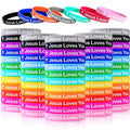 Set of colorful silicone wristbands with cross and “Jesus Loves You” text